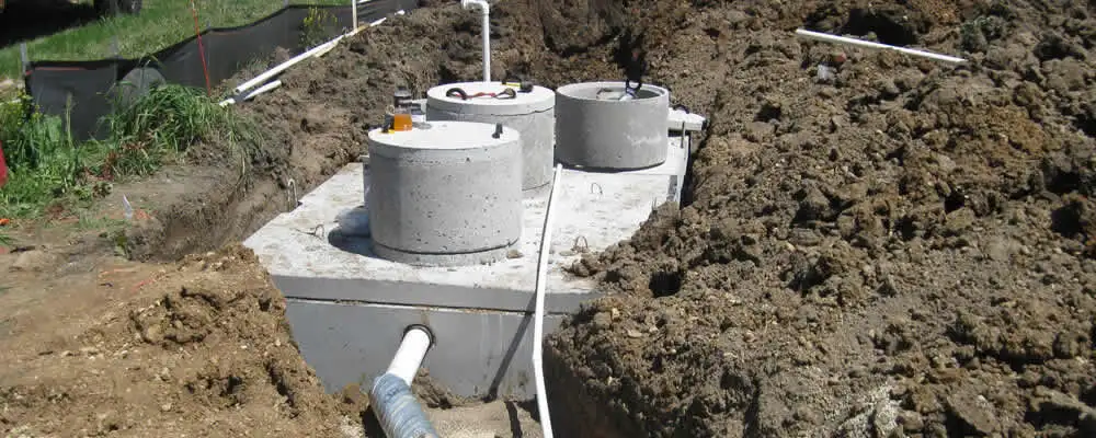 Septic system repair and installation site with tank access ports in Troy, MI